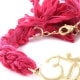 Ettika - Geflochtenes, rosafarbenes und silberne Baumwoll-Armband mit Om in Gelbgold